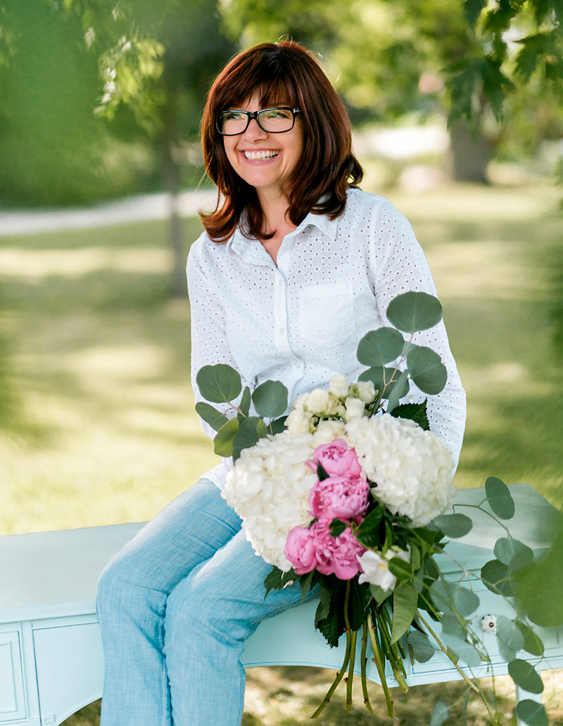 Kathy Sitting with Flowers